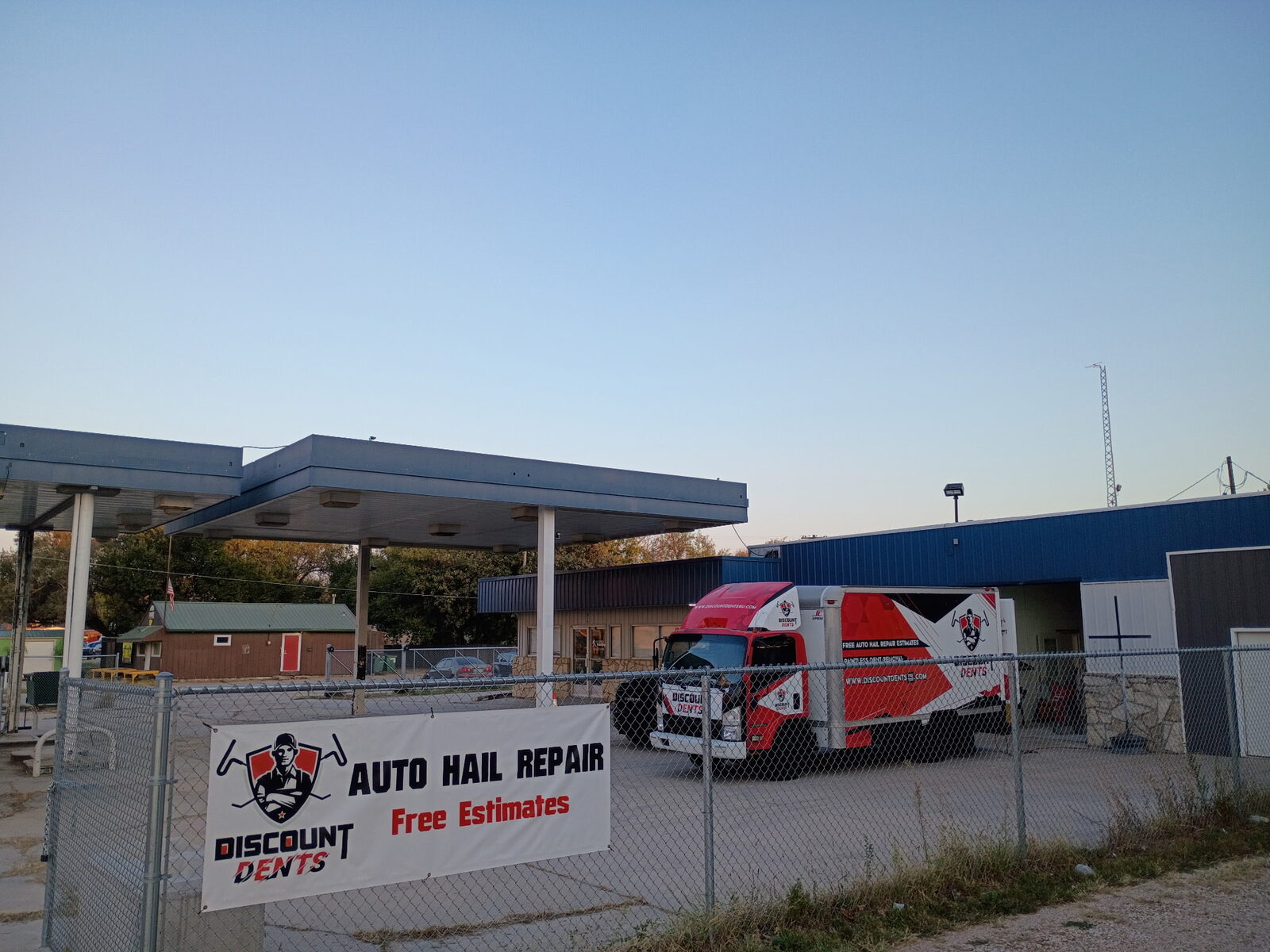 Auto hail repair banner and Discount Dents box truck at the Emporia, Kansas shop