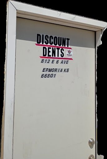 Discount Dents sign on the shop entrance door at 812 E 6th Ave, Emporia, Kansas